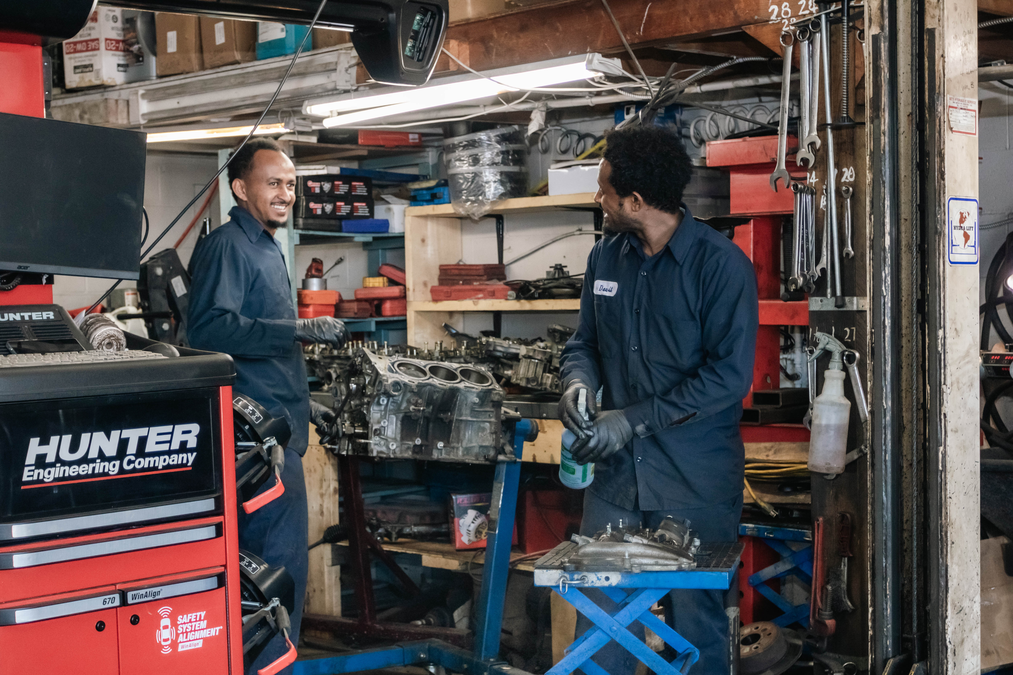 Mechanics servicing an engine in the shop