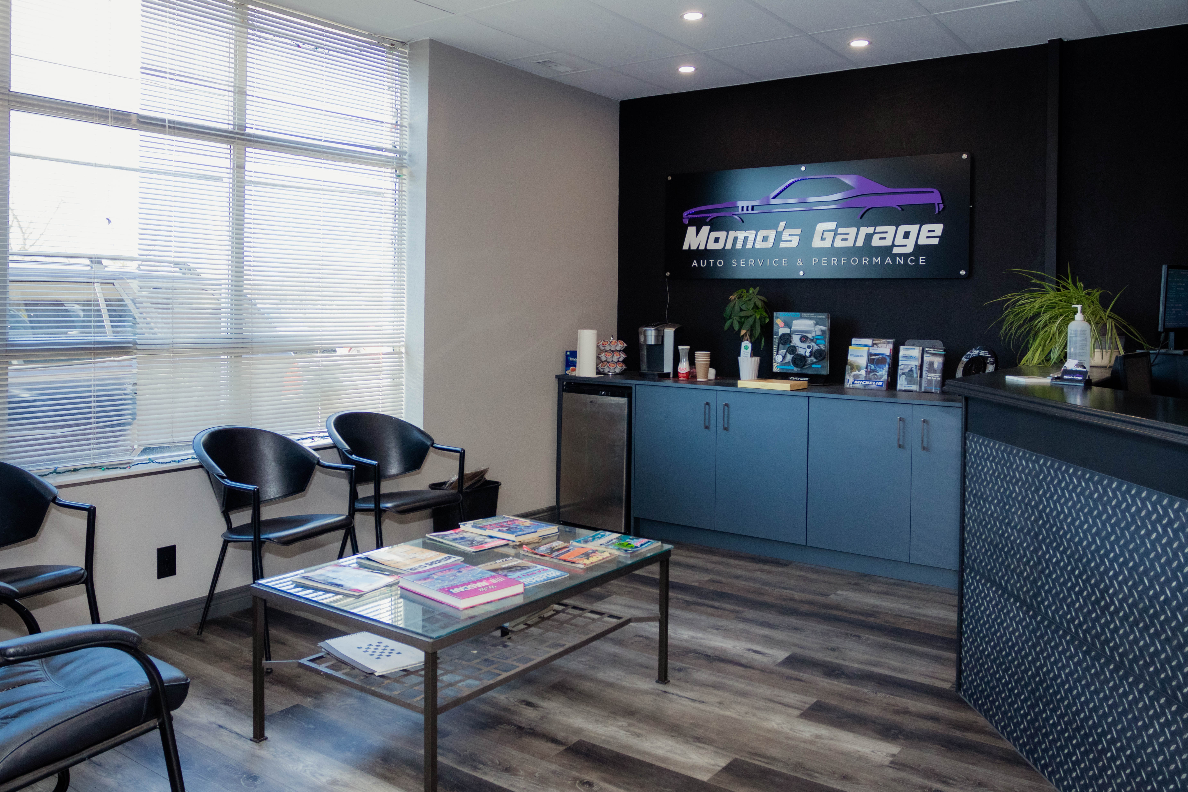 Reception area of an auto repair shop with a dark branded wall