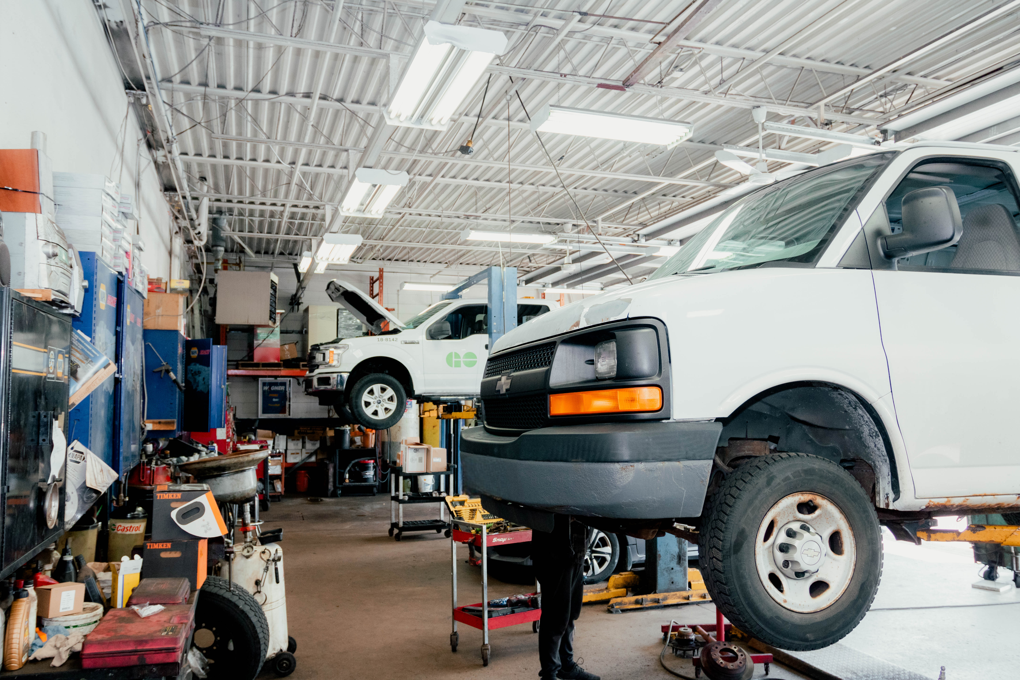 Fleet service bay with a truck being serviced on a lift