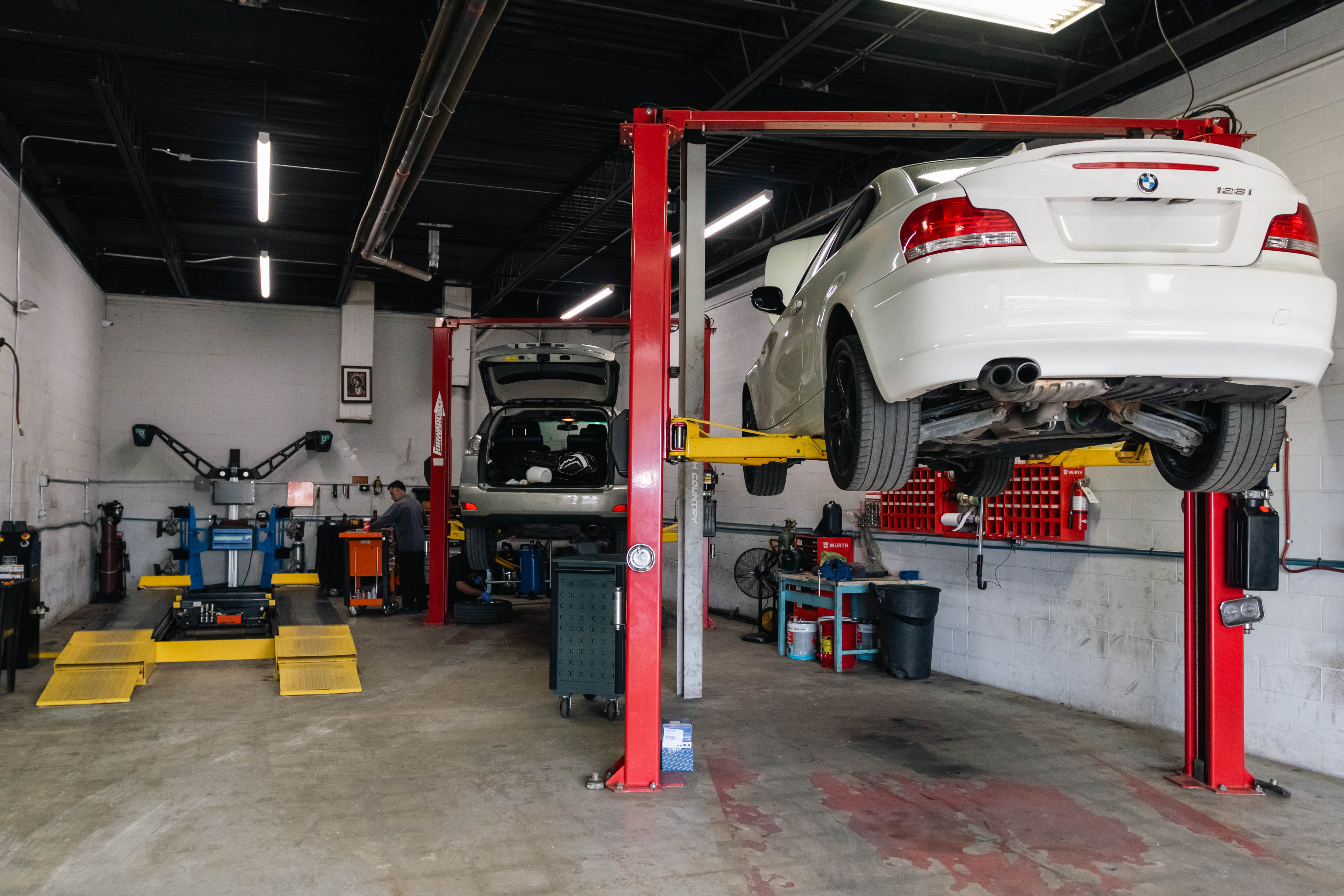 Quick lube shop with a car on a hoist in a bright bay