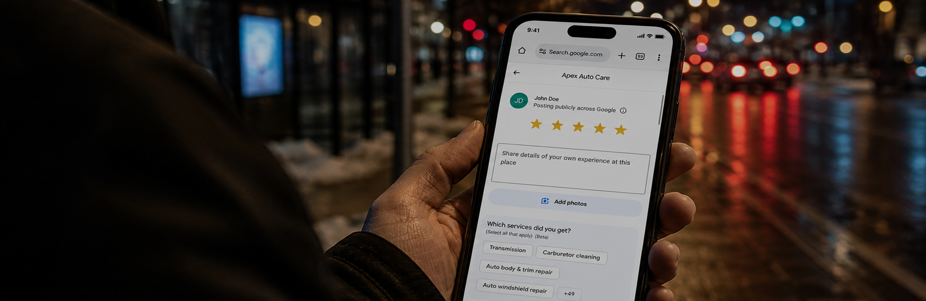 Person holding phone showing a Google review
